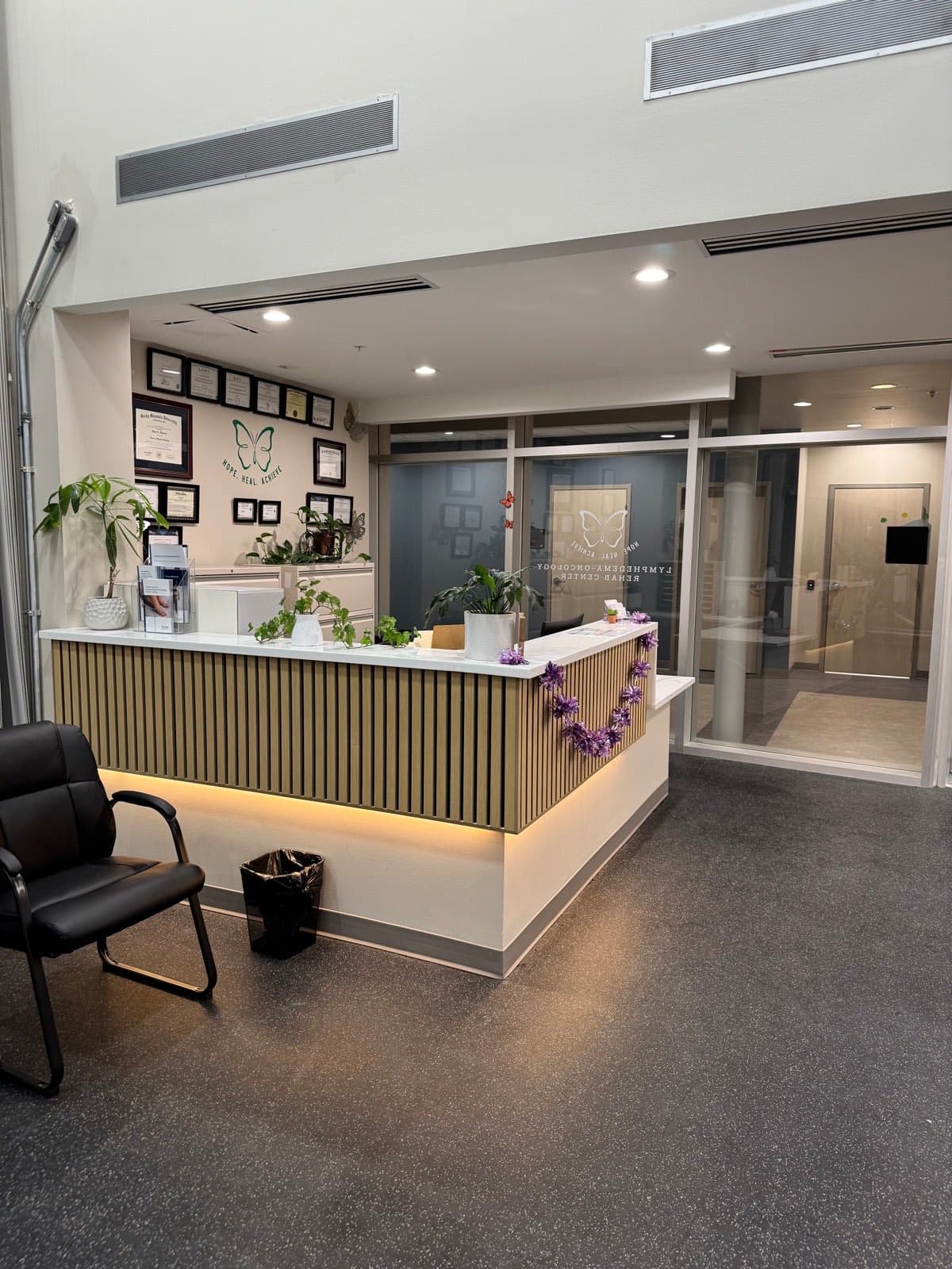 The LORC front desk beneath the team's wall of certifications and credentials